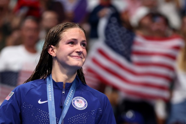 Silver Medalist Katie Grimes of Team United States reacts as she stands on the podium during the Swimming medal ceremony after the Women's 400m Individual Medley Final on day three of the Olympic Games Paris 2024 at Paris La Defense Arena on July 29, 2024 in Nanterre, France. (Photo by Sarah Stier/Getty Images)