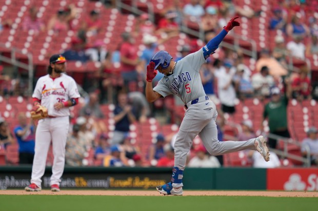 Chicago Cubs' Christopher Morel (5) rounds the bases after hitting a solo home run as St. Louis Cardinals third baseman Brandon Crawford, left, stands by during the eighth inning of a baseball game Sunday, July 14, 2024, in St. Louis. (AP Photo/Jeff Roberson)