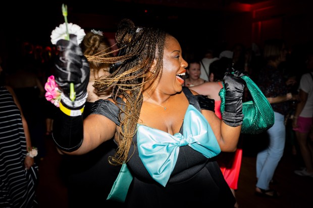 Crystal Avenetti poses at Earlybirds Club's, a dance club that starts early and ends early, 90's Prom party at Color Club in Chicago on July 19, 2024. Avenetti made the blue bow herself. (Tess Crowley/Chicago Tribune)