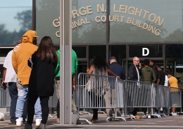 People arrive at the Leighton Criminal Court building wait outside for the doors to open on July 7, 2021. (Antonio Perez/ Chicago Tribune)