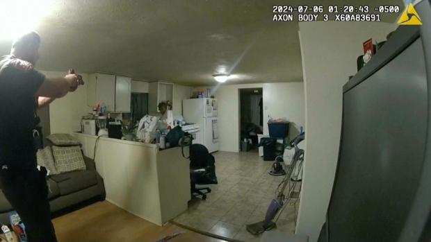 In this image taken from body camera video released by Illinois State Police on Monday, July 22, 2024, former Sangamon County Sheriff's Deputy Sean Grayson, left, points his gun at Sonya Massey, who called 911 for help, before shooting and killing her inside her home in Springfield, Ill., July 6, 2024. (Illinois State Police)