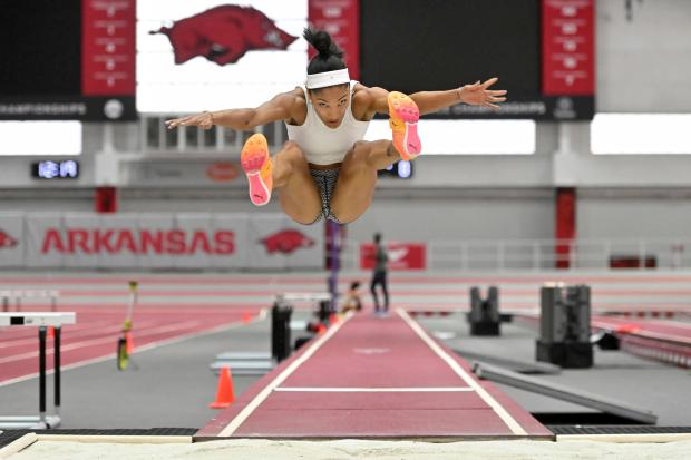 Olympic long jumper Tara Davis-Woodhall makes a practice jump at the Randal Tyson Track Center on Jan. 18, 2024, in Fayetteville, Ark. (AP Photo/Michael Woods)