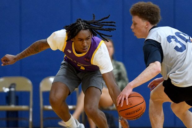 Waukegan's Simereon Carter makes a move to steal the ball from a St. Viator player at a summer league basketball tournament hosted by Warren Township High School in Gurnee, Thursday, June 13, 2024. (Rob Dicker / News-Sun).