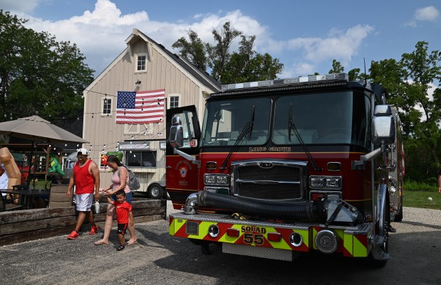 Long Grove fire personnel bring apparatus for families to see at Christmas in July at Brothers' Field in downtown Long Grove on July 13, 2024. (Karie Angell Luc/Lake County News-Sun)