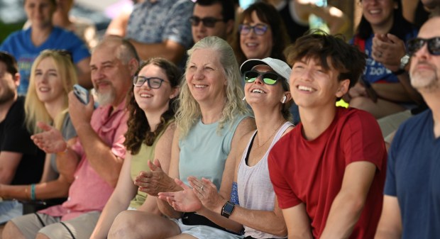 Third from right, with airpod earphones, neon-tinted sunglasses and white hat is Brooke Folkrod of Libertyville among spectators on July 5, 2024 at the Dog Days of Summer hosted by the Knights of Columbus (Council #3674). (Karie Angell Luc/Lake County News-Sun)