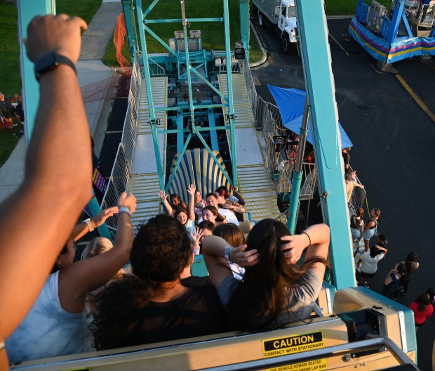 Below, on Pharaoh's Fury, second row, from right, are Andy Styx of Libertyville and daughter Grace, 8, a rising third-grader at Vernon Hills Days on July 20, 2024 along Century Park. (Karie Angell Luc/Lake County News-Sun)