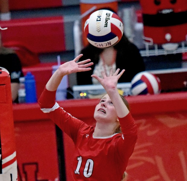 Naperville Central's Sarah Butler sets the ball during a DuPage Valley Conference match against Naperville North in Naperville on Tuesday, Sept. 26, 2023. (Jon Langham / Naperville Sun)