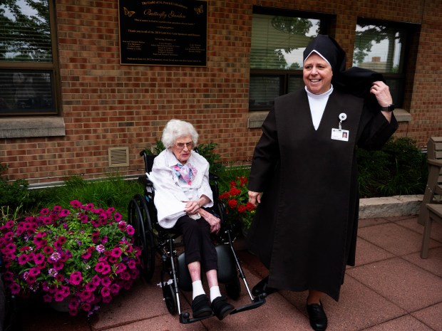 Christine Cappetta sits outside in a garden at St. Patrick's Residence Nursing & Rehabilitation in Naperville with Sr. Anthony Veilleux, director of mission integration for. St. Patrick's, on July 9, 2024. Cappetta is turning 102 this year. (Tess Kenny/Naperville Sun)