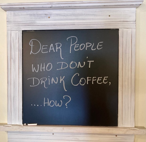 This amusing sign says it all at Yogi's Cafe, a Naperville coffee shop that's been in business since 2019. (Steve Metsch/Naperville Sun)