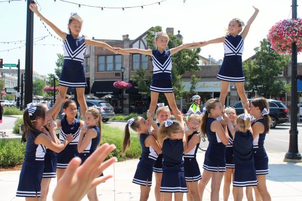 New Trier Junior Cheer Team performed during the annual Wilmette Sidewalk Sale in downtown Wilmette held on July 12 and 13. (Gina Grillo/Pioneer Press)