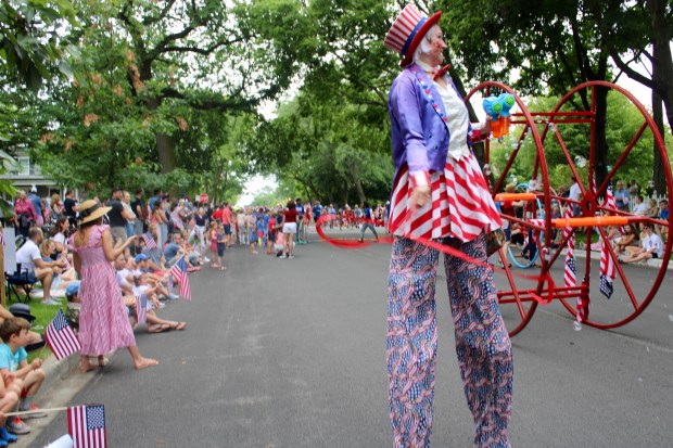 Winnetka's July Fourth parade had 49 entries with local organizations and neighbors marching alongside orchestras, pipe bands, jugglers and Uncle Sam on stilts. (Gina Grillo/Pioneer Press)