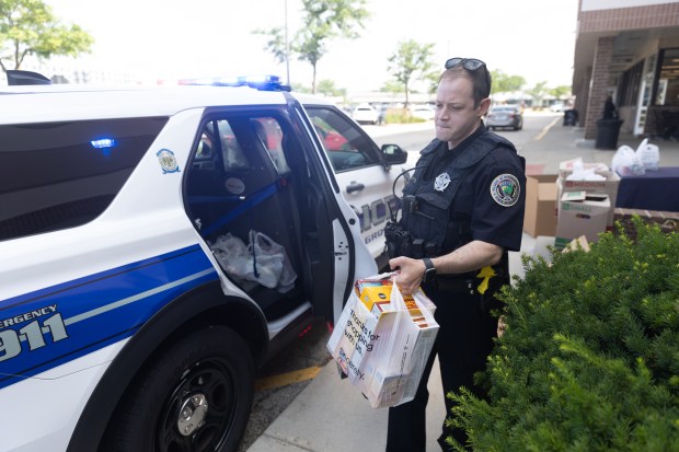 Officer Drew Stephans of the Buffalo Grove Police Department collects food donations at Jewel-Osco in Buffalo Grove on Saturday, June 29, 2024. (Trent Sprague/for the Pioneer Press)