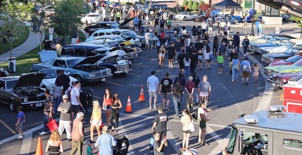 A crowd moves along Conti Parkway during the Summer in the Circle car show June 14, 2024 in Elmwood Park. (H. Rick Bamman /for Pioneer Press)