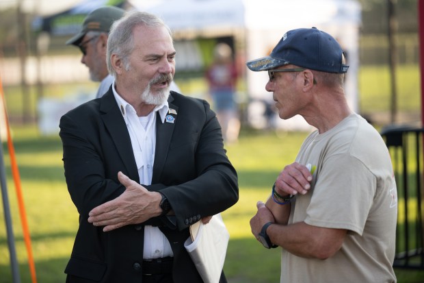 American Legion Post 20 Commander Kevin Dvorak, on left, speaks with Disabled American Veterans Chapter 80 Commander Butch Fortner as the Lake County Corn Dogs host the U.S. Military WarDogs on Thursday, July 18, 2024. (Kyle Telechan/for the Post-Tribune)