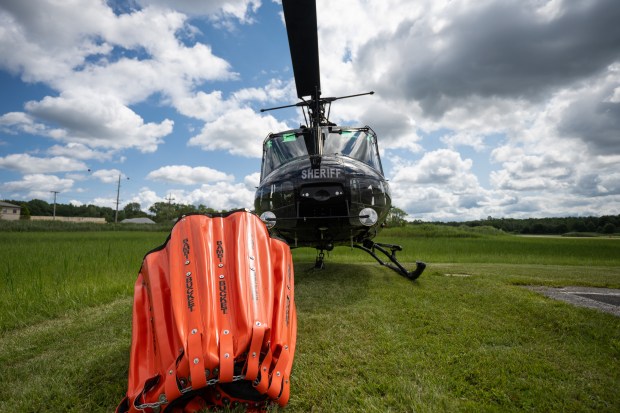 A Bambi Bucket, used to carry water from ground water sources to douse fires, sits on the ground attached to a Lake County Sheriff's Department helicopter at Griffith Airport on Thursday, July 18, 2024. (Kyle Telechan/for the Post-Tribune)