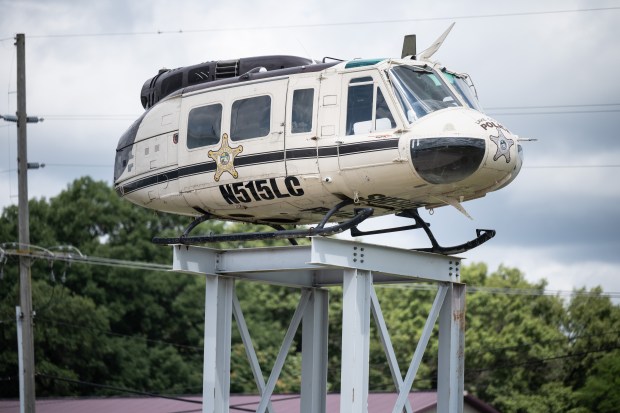 A Lake County Sheriff's Department helicopter fuselage, to be used in future training exercises, sits atop a tower constructed by local union workers at Griffith Airport on Thursday, July 18, 2024. (Kyle Telechan/for the Post-Tribune)