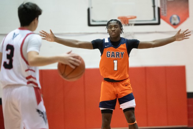 West Side's Reginald "Trey" Hinton, right, guards Lake Station's Aiden Rowan during a game in Lake Station on Tuesday, Nov. 28, 2023. (Kyle Telechan / Post-Tribune)