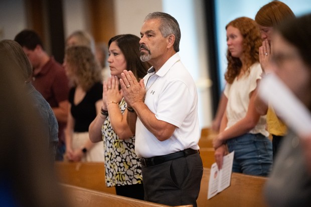 Congregants fold their hands in prayer during the Eucharistic Congress Commissioning mass at St. Patrick Catholic Church in Chesterton on Monday, July 15, 2024. (Kyle Telechan for the Post-Tribune)