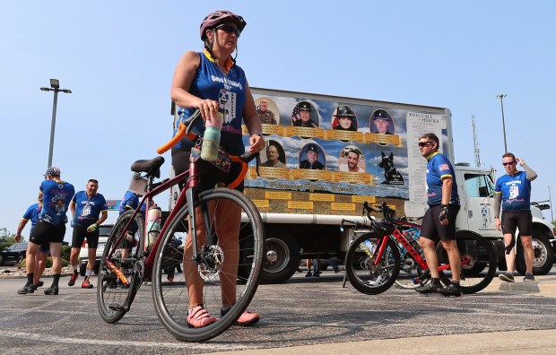 Tami Tebbe, wife of Tipton County Sheriff Matt Tebbe, (left) waits for the baggage truck to unload during the 23rd annual Cops Cycling for Survivors bicycle ride around Indiana comes through the region. The ride pays respect to Indiana's fallen law enforcement heroes. The event lets their survivors know they and their loved ones are not forgotten. Riders stopped at the Fairfield Inn at Merrillville on Friday, July 12, 2024. (John Smierciak/for the Post Tribune)