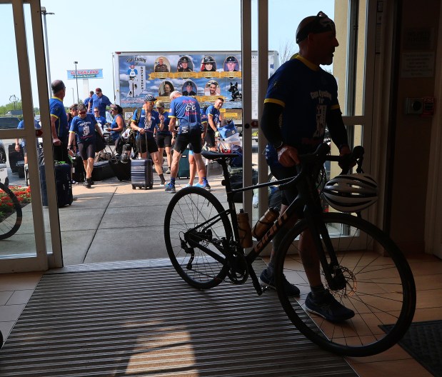 Riders carry their luggage and roll their bikes into the hotel during the 23rd annual Cops Cycling for Survivors bicycle ride around Indiana comes through the region. The ride pays respect to Indiana's fallen law enforcement heroes. The event lets their survivors know they and their loved ones are not forgotten. Riders stopped at the Fairfield Inn at Merrillville on Friday, July 12, 2024. (John Smierciak/for the Post Tribune)