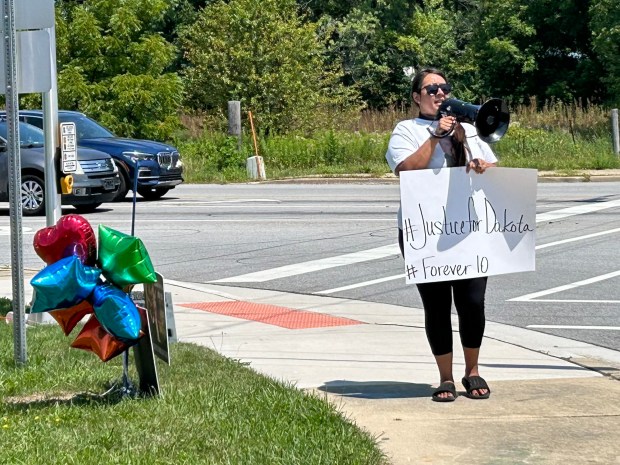 Eva Parrish, Dakota Levi Stevens' aunt, uses a megaphone on Saturday, July 27, 2024, at the intersection of Indiana 149 and US 6 as she and other family members seek justice in the death of Dakota, 10, who died in foster care. (Amy Lavalley/Post-Tribune)