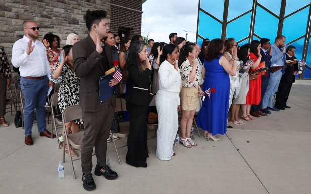 New citizens take the oath during the naturalization of 50 people from 30 countries by federal Magistrate Judge Abizer Zanzi at the Pavilion at Wolf Lake in Hammond on Wednesday, July 3, 2024. (John Smierciak/for the Post Tribune.