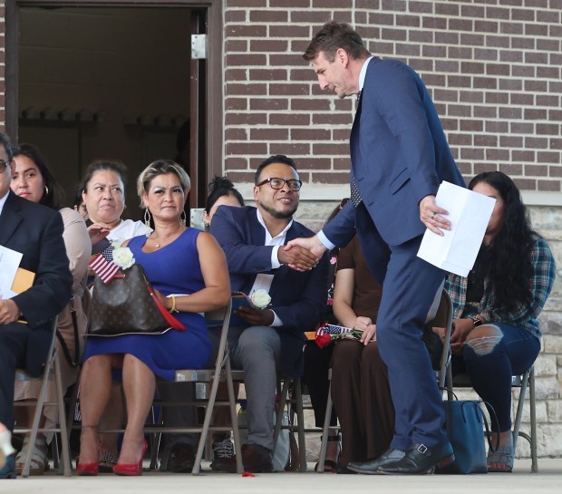 U.S. Representative Frank MrVan greets the new citizens during the naturalization of 50 people from 23 countries by federal Magistrate Judge Abizer Zanzi at the Pavilion at Wolf Lake in Hammond on Wednesday, July 3, 2024. (John Smierciak/for the Post Tribune.
