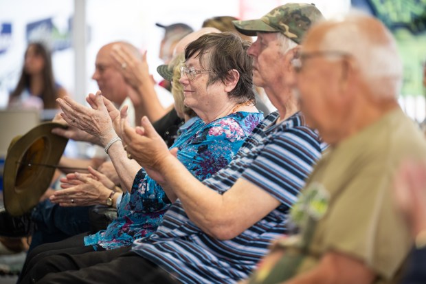 Visitors applaud as Army veteran and photographer Vince Lusk speaks to a crowd during the Porter County Fair's Veterans Day program in Valparaiso on Wednesday, July 24, 2024. (Kyle Telechan/for the Post-Tribune)