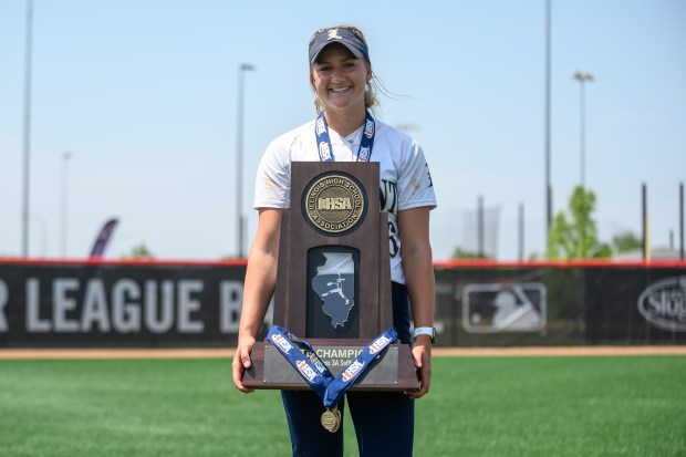 Sage Mardjetko (16) holds the Class 3A state championship trophy after Lemont defeated Antioch in 12 at the Louisville Slugger Sports Complex in Peoria on Saturday, June 10, 2023.