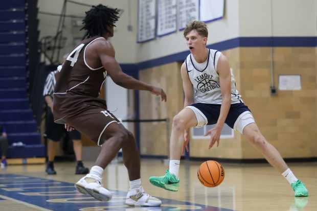 Lemont's Gabe Sularski (73) makes a dribble move on Mount Carmel's Cameron Thomas (14) during a game in the Riverside-Brookfield Shootout on Saturday, June 22, 2024. (Troy Stolt/for the Daily Southtown)