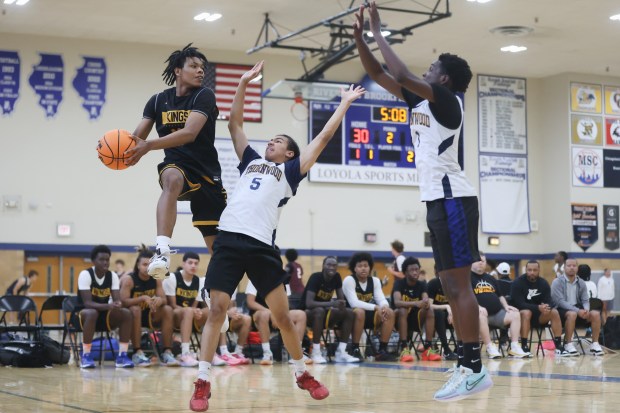 St. Laurence's EJ Mosley (11) makes a leaping pass to keep the ball in play during a game against Thornwood in the Riverside-Brookfield Shootout on Sunday, June 23, 2024. (Troy Stolt/for the Daily Southtown)