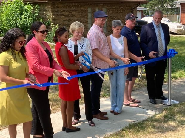 Officials from Lansing and the Metropolitan Water Reclamation District mark the completion of a flood control project July 30, 2024. (Mike Nolan / Daily Southtown)