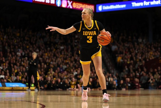 Sydney Affolter (3), a Marist graduate, directs the offense against Minnesota during a Big Ten game at Williams Arena in Minneapolis on Wednesday, Feb. 28, 2024. (Brian Ray / Iowa athletics photo)