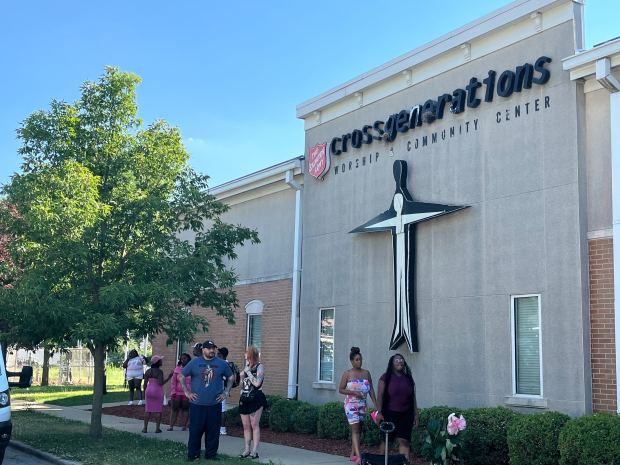 People gather June 21, 2024, outside the Salvation Army Worship and Community Center in Blue Island after gunmen opened fire during a funeral banquet, officials said. (Olivia Stevens/Daily Southtown)