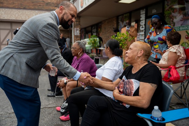 Jason House, a Dolton trustee who is running for mayor of Dolton, greets Brenda Richardson, a Dolton resident, during a election campaign kickoff July 28, 2024, at Free N Deed Market. (Vincent Alban/for Chicago Tribune)