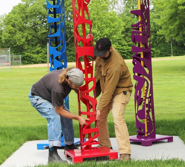 Workers install sculptures by artist William O'Brien in May at Brassie Avenue and Flossmoor Road, a busy, active recreation area in Flossmoor. The sculptures are among the newest public art pieces in the village. (Village of Flossmoor)