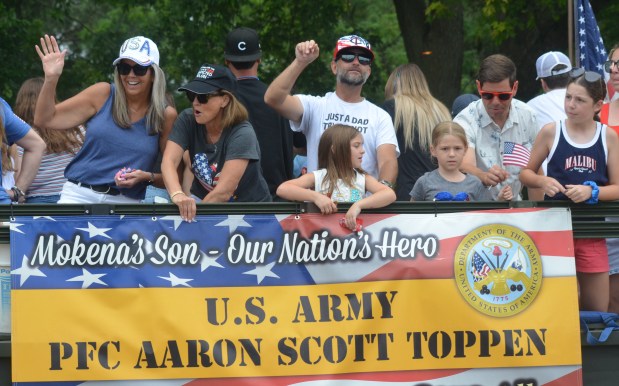 Members of the float in the late Aaron Toppen's honor greet the thousands of parade goers July 4, 2024, in Mokena. (Jeff Vorva/for the Daily Southtown)