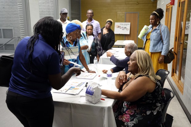 Thornton Township Assessor Cassandra Elston, seated at right, speaks to residents about property tax increases in the Chicago's South suburbs at TF North High School in Calumet City on July 22, 2024. (Terrence Antonio James/Chicago Tribune)