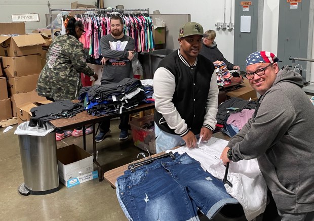 A group of volunteers and a staff member from St. Coletta's of Illinois' Community Day Services program in Tinley Park sort clothes at My Joyful Heart in Mokena. (St. Coletta's of Illinois)