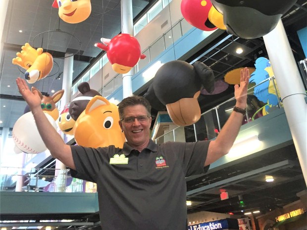 David Raymond, creator of the Mascot Hall of Fame, beams while in the entrance lobby of 17 giant floating sports mascot heads as one of his favorite highlights of the Mascot Hall of Fame Museum in Whiting.