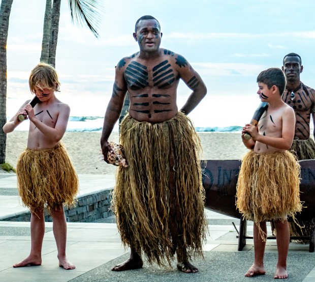 Daring travelers join a Fijian warrior at the International Hotel & Resort's evening Torch Lighting Ceremony, Fiji Islands. (Steve Haggerty/TNS)