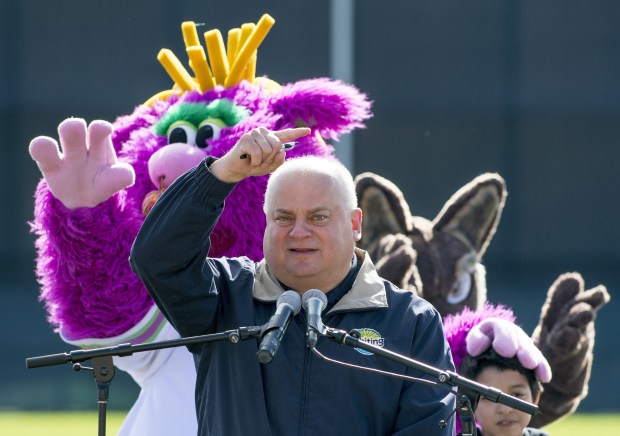 Mayor Joe Stahura speaks at the Oil City Stadium while Reggy (the mascot) has some fun in the background as school children and city and county dignitaries gathered to break ground on the new Mascot Hall of Fame project in downtown Whiting, IN., on Friday, Oct. 21, 2016.