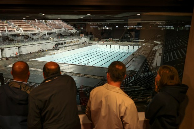 People view the Olympic swimming pool, June 12, 2024 at the Paris La Defense Arena, in Nanterre, outside Paris. The Paris La Defense Arena will host the swimming and some water polo events during the Paris 2024 Olympic Games. (Thomas Padilla/AP)