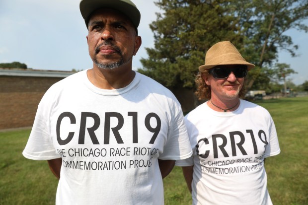 Franklin Cosey-Gay, left, and Peter Cole, of the Chicago Race Riot of 1919 Commemoration Project, watch during a ceremony to unveil a headstone for Eugene Williams at Lincoln Cemetery in Blue Island on on July 24, 2021. (Chris Sweda/Chicago Tribune)