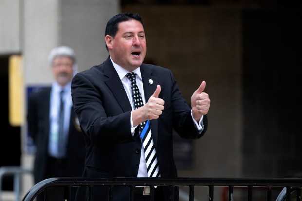 State Rep. John Cabello gives thumbs up to protesters calling for the government to reopen Illinois as they rally outside the Bank of Springfield Center on May 20, 2020, in Springfield. (Erin Hooley/Chicago Tribune)