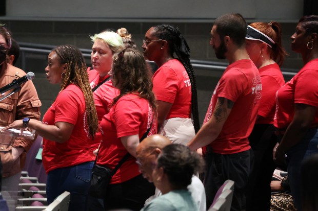 Amaziah Burton, left, a special education teacher, addresses the Chicago Board of Education at William Jones College Preparatory school in Chicago on July 16, 2024. (Terrence Antonio James/Chicago Tribune)