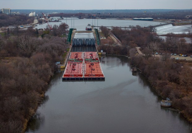A barge moves through the lock at the Brandon Road Lock and Dam on the Des Plaines River in Joliet, Dec. 5, 2023. (E. Jason Wambsgans/Chicago Tribune)