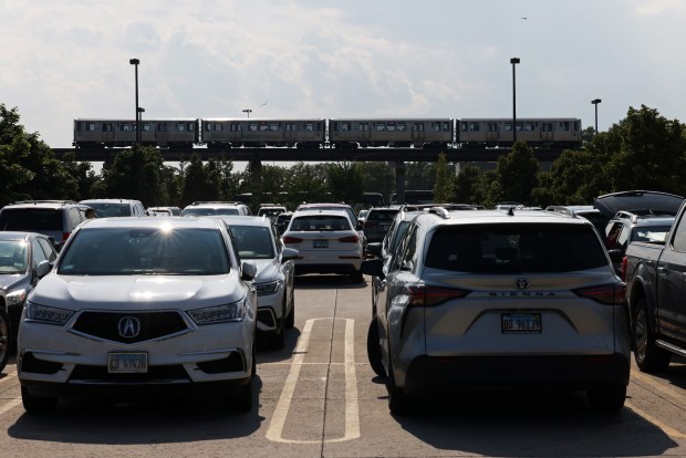 A CTA Pink Line train moves past a parking lot at a Costco Wholesale in the 1400 block of South Ashland Avenue on July 10, 2024, in Chicago. (John J. Kim/Chicago Tribune)