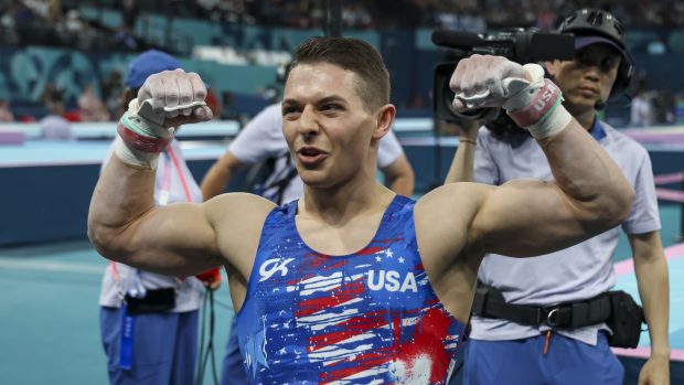 Paul Juda of Team USA celebrates his performance on the horizontal bar during the qualification for the men's team gymnastics on July 27, 2024, at Bercy Arena during the Paris Olympics. (Brian Cassella/Chicago Tribune)