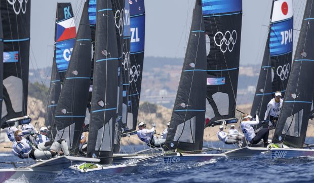 USA's Maggie Shea, center, and Stephanie Roble compete against a crowded field in a women's skiff sailing race, July 28, 2024, at Marseille Marina during the Paris Olympics. (Brian Cassella/Chicago Tribune)